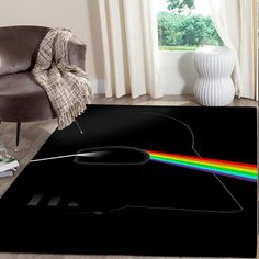 a black area rug with a rainbow light coming out of the center in front of a chair