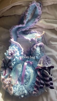 a crocheted bag with a bow on it