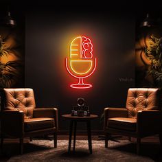 two chairs and a table in front of a wall with a neon sign on it