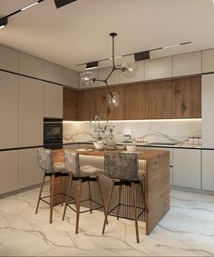 a modern kitchen with marble counter tops and bar stools