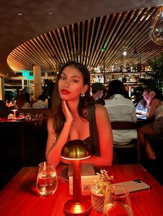 a woman sitting at a table in a restaurant