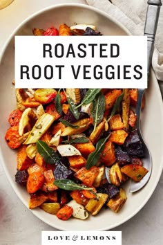 roasted root veggies in a white bowl with a fork and spoon on the side