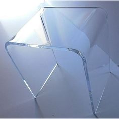 a clear glass sculpture sitting on top of a table