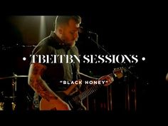 a man holding a guitar in front of a microphone with the words tbethn session on it