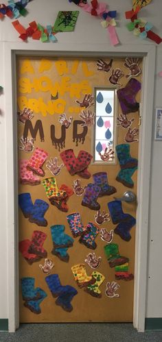 a door decorated with paper cut outs and colorful decorations on the front entrance to a classroom