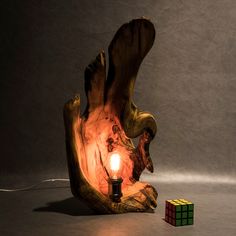 a light that is sitting on top of a wooden object with a candle in it