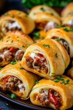 a plate filled with meat and cheese pastries