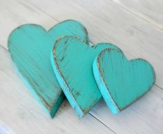 two wooden hearts with words written on them