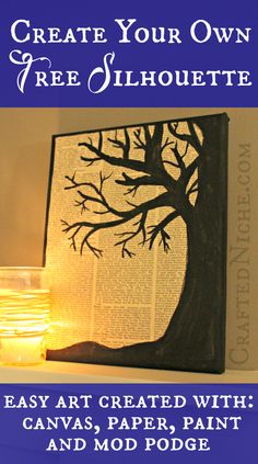 a lit candle sitting on top of a shelf next to a tree cut out of an old book