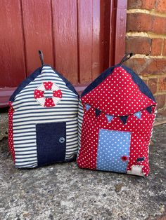 two little houses made out of fabric sitting on the ground