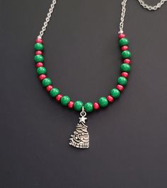 Silver Christmas tree charm with green glass and red pearl beads.  I can adjust the length or add an extender upon request! Christmas Beaded Necklaces With Colorful Beads For Gift, Christmas Gift Beaded Necklaces With Colorful Beads, Christmas Holiday Necklace With Round Beads, Christmas Gift Colorful Beaded Necklaces, Christmas Gift Beaded Necklaces With Round Beads, Green Necklace Christmas Gift, Christmas Jewelry Diy Necklace, Christmas Beaded Necklaces, Christmas Necklace Diy