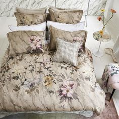 a bed with floral comforter and pillows on it