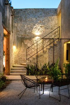 an image of a table and chairs in front of stairs