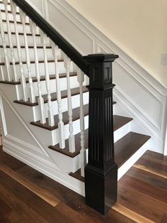 an image of a stair case in the house with wood floors and white railings