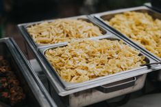 three trays filled with different types of food