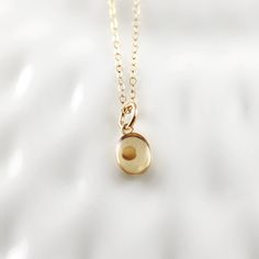 "\"Truly I tell you, if you have faith as small as a mustard seed, you can say to this mountain, 'Move from here to there,' and it will move. Nothing will be impossible for you.\" - Matthew 17:20 This dainty handmade pendant is a single mustard seed set in resin in a 14K gold filled bezel. Each pendant is created in our studio using high grade resin for years of wear. Pendant measures just 8mm tall by 6mm wide (minus top loop) for a simple and understated look. This necklace will serve as such a Yellow Initial Pendant Necklace For Gifts, Faith Of Mustard Seed, Mustard Seed Bible Verse, Diamond Cross Necklace Gold, Mustard Seed Necklace, Bible Verse Necklace, Seed Necklace, Floating Diamond Necklace, Matthew 17