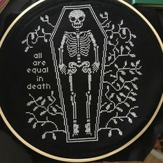 a cross - stitch skeleton is on the floor next to some books