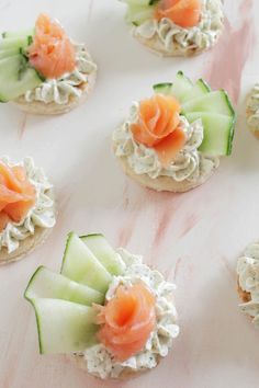 small crackers with cucumbers and salmon on them