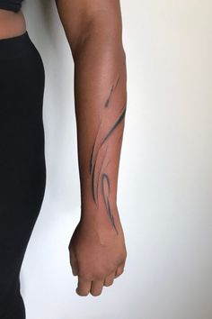 a woman's arm with a tattoo on it and a black leggings