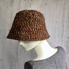 Crochet bucket hat Hat crocheted from a soft,  colorfully dyed yarn blend - 25% wool and 75% acrylic. The colors of autumn shimmer beautifully in the hat. Small brim hats can be modified in different ways.    Hat sizes: Head size 21 1/2 - 23 1/2 inches The total height of the hat is 24 cm Hand Knitted Adjustable Hat For Fall, Multicolor Wool Hat For Fall, One Size Wide Brim Cloche Hat For Fall, One Size Fall Wide Brim Cloche Hat, Multicolor Hand Knitted Brimmed Hats, Multicolor One Size Cloche Hat With Curved Brim, Multicolor One-size Cloche Hat With Curved Brim, Fall Wide Brim Cloche Hat, Multicolor Cloche Hat With Curved Brim