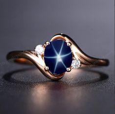 14k Rose Gold Star Blue Sapphire Ring, Lindy Star Sapphire, 925 Sterling Silver, Star Gemstone, Lindy Star Ring, Star Sapphire Jewelry ★ Settings ☆ Metal - 925K Sterling Silver/ 14k Rose Gold ☆ band Color - Rose / White / Yellow ⍟ The ring size shown in the pictures is 7 US. ★ Main Stone ☆ Stone - Lab Created blue star sapphire �☆ Size - 6×8 mm ☆ Shape - Oval ☆ Color Grade- AAA ☆ Certificate of Authenticity and lifetime warranty by Dkjewelrystore ☆ Side Stone - Round CZ Diamonds ★ Features : ☆ Ha Star Sapphire Engagement Ring, Star Sapphire Jewelry, Sapphire Ring Designs, Pretty Engagement Rings, Star Sapphire Ring, Jewelry Star, Shiny Rings, Blue Star Sapphire, Star Blue