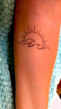 a woman's foot with a tattoo on it and the sun above her head