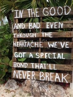 a wooden sign that says in the good and bad even through the heartache we've got a special bond that i never break