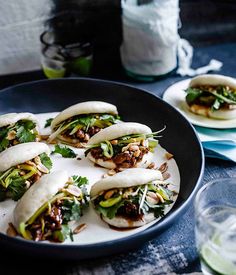 some tacos are sitting on a plate and ready to be eaten