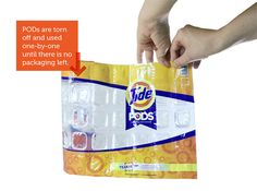 a package of tide pods is being held by someone's hand