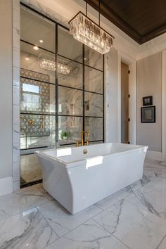 a large white bath tub sitting inside of a bathroom