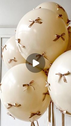 balloons with bows tied to them are being held in front of a mirror and door