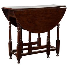 an old wooden table with two legs and a glass top on the bottom, against a white background