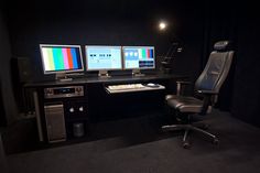 two computer monitors sitting on top of a desk