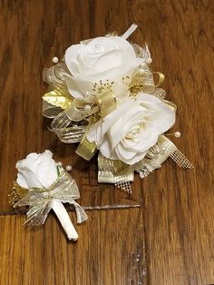 two bridal bouquets on a wooden table, one white and the other gold