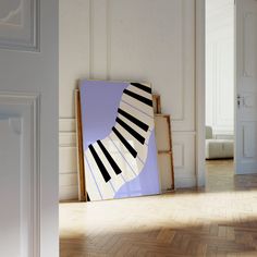 an abstract painting on the wall next to a wooden floor in a room with white walls and parquet floors