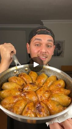 a man holding a pan filled with food