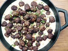 meatballs and pine nuts in a skillet