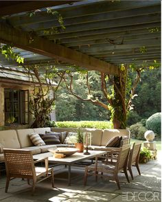 an image of a patio with furniture and trees in the background, taken on instagram