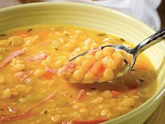 a green bowl filled with corn and carrots