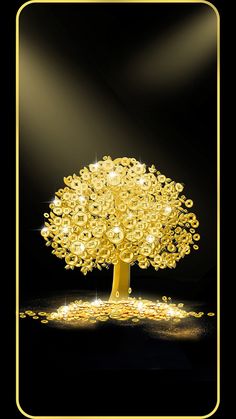 a golden tree with lots of lights on it's branches and some gold coins around it