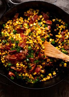 a skillet filled with corn and bacon