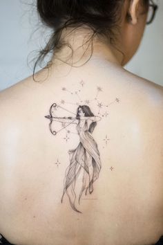 a woman with a bow and arrow tattoo on her back