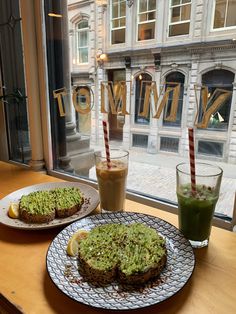 there are two cakes on the table next to each other with drinks in front of them