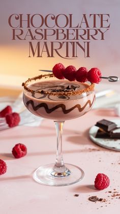 a chocolate raspberry martini in a glass on a table with some raspberries