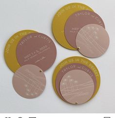 three circular coasters with the names of four different cities