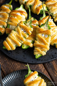 some food is on a black plate with googly eyes