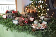 a table topped with lots of desserts and trees