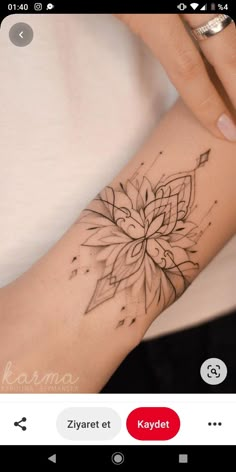 a woman's arm with a flower tattoo on it