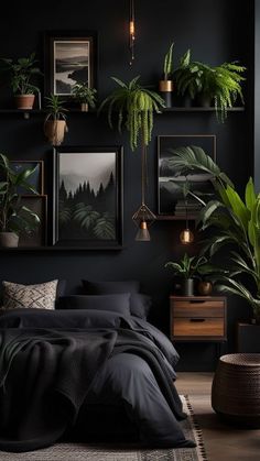 a bedroom with black walls, plants and pictures on the wall above the headboard