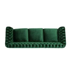 a green velvet sofa with four pillows on it's back and the seat upholstered